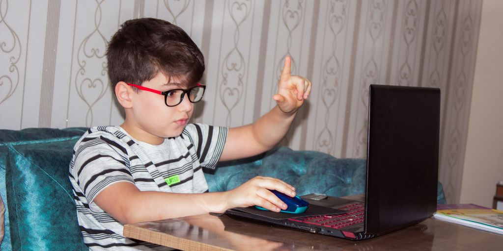 man in black and white stripe shirt using black laptop computer