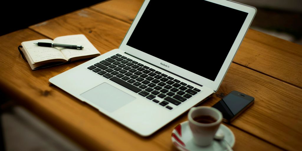 MacBook Air on brown wooden table